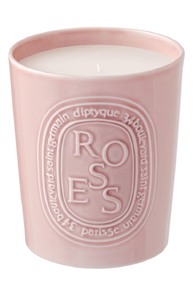 a pink candle with the words roses on it