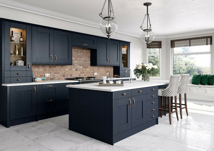 a large kitchen with blue cabinets and marble counter tops is featured in this magazine cover