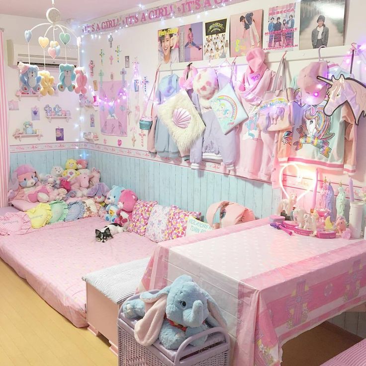 a room filled with lots of stuffed animals on top of pink bedspreads