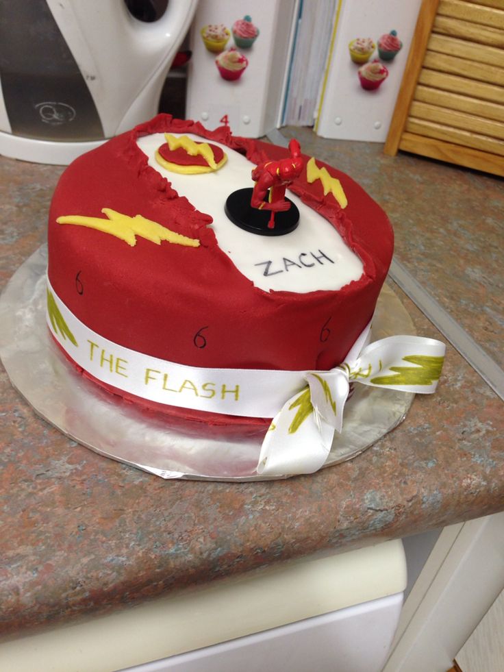 a birthday cake with the flash symbol on it