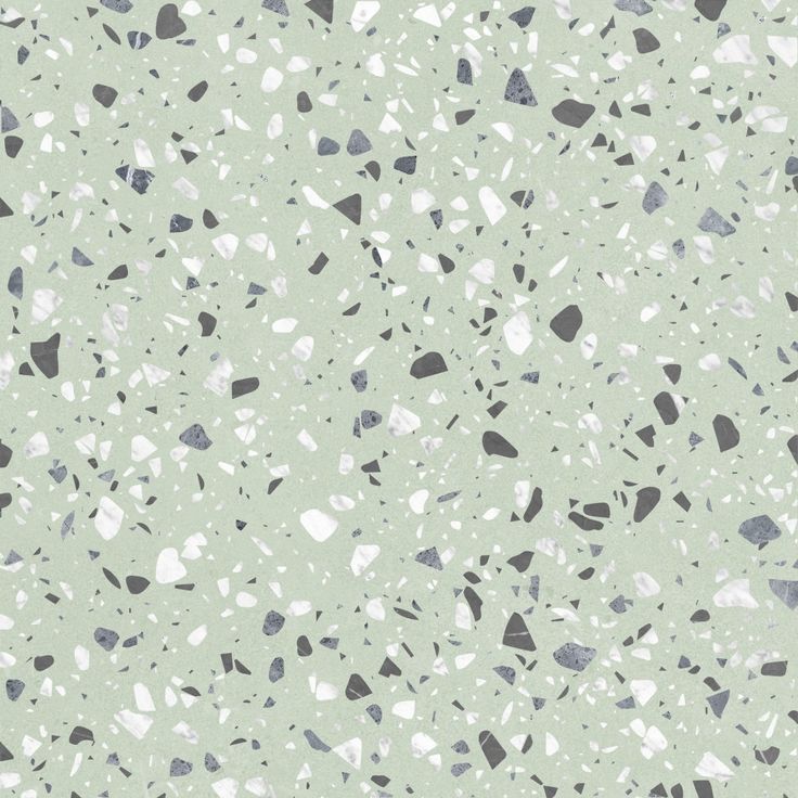 a green and white speckled surface with small black dots on the top, gray spots on the bottom