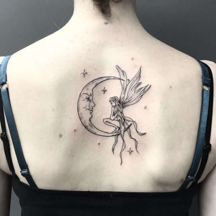 a woman with a tattoo on her back is looking at the moon and fairy tale