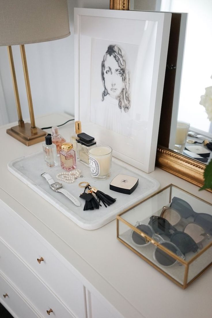 a vanity with makeup and accessories on it