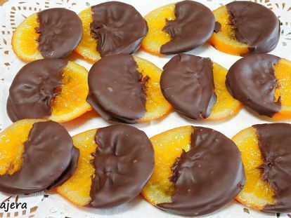 chocolate covered orange slices on a white doily