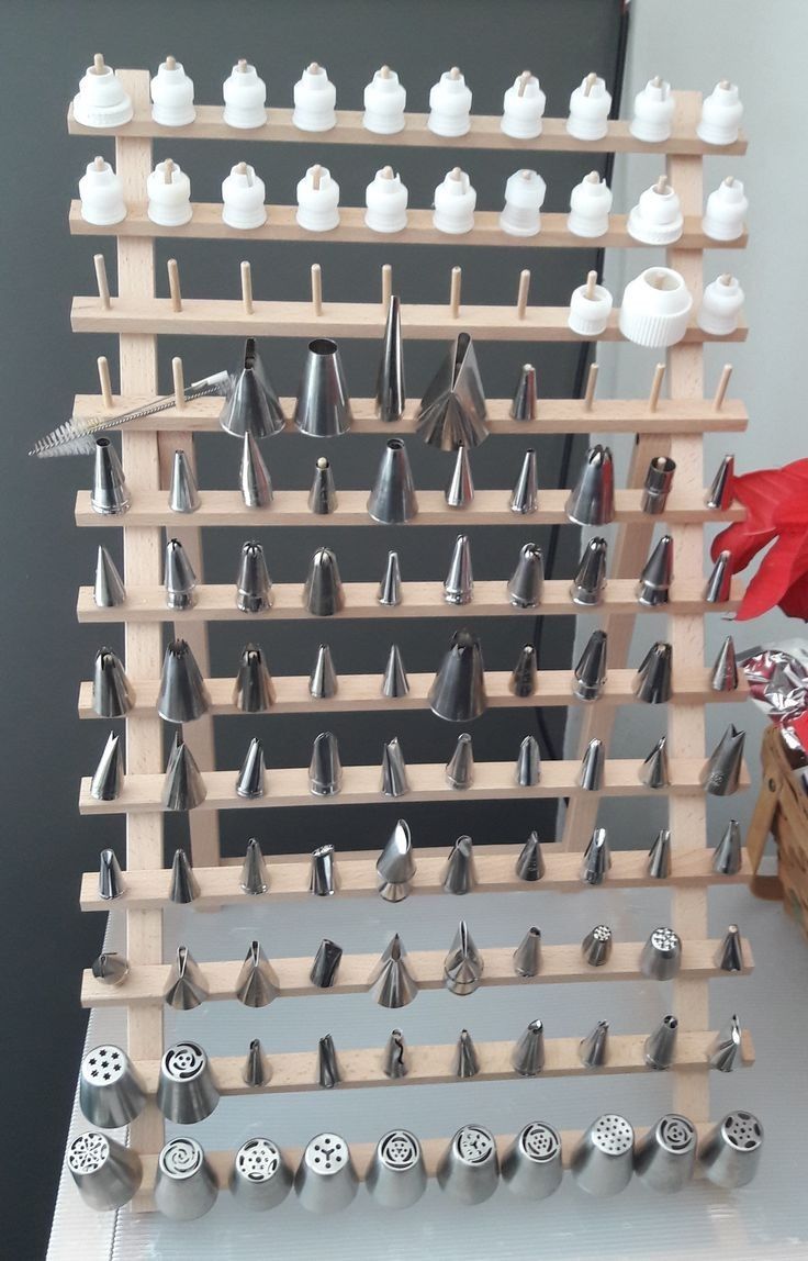 a wooden rack with many different types of knobs on it and some other items