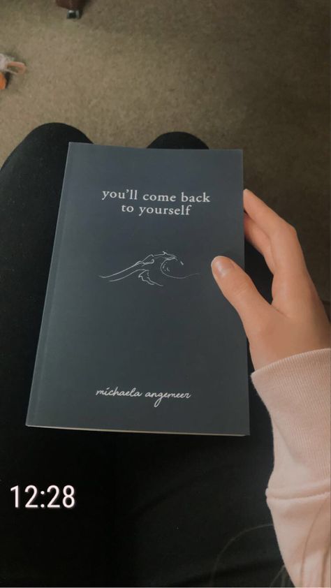 someone is holding up a book that says, you'll come back to yourself