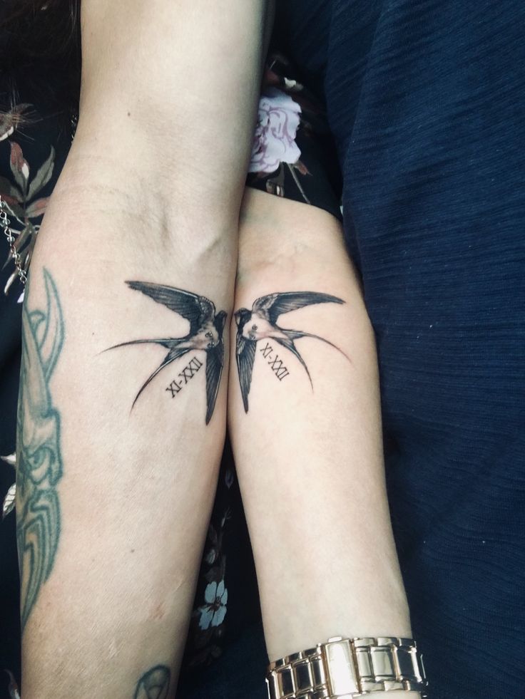 two people with matching tattoos on their arms