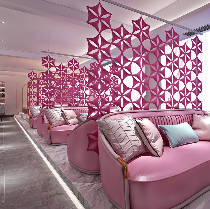 a living room with pink couches and pillows