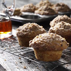 muffins cooling on a rack with honey in the background