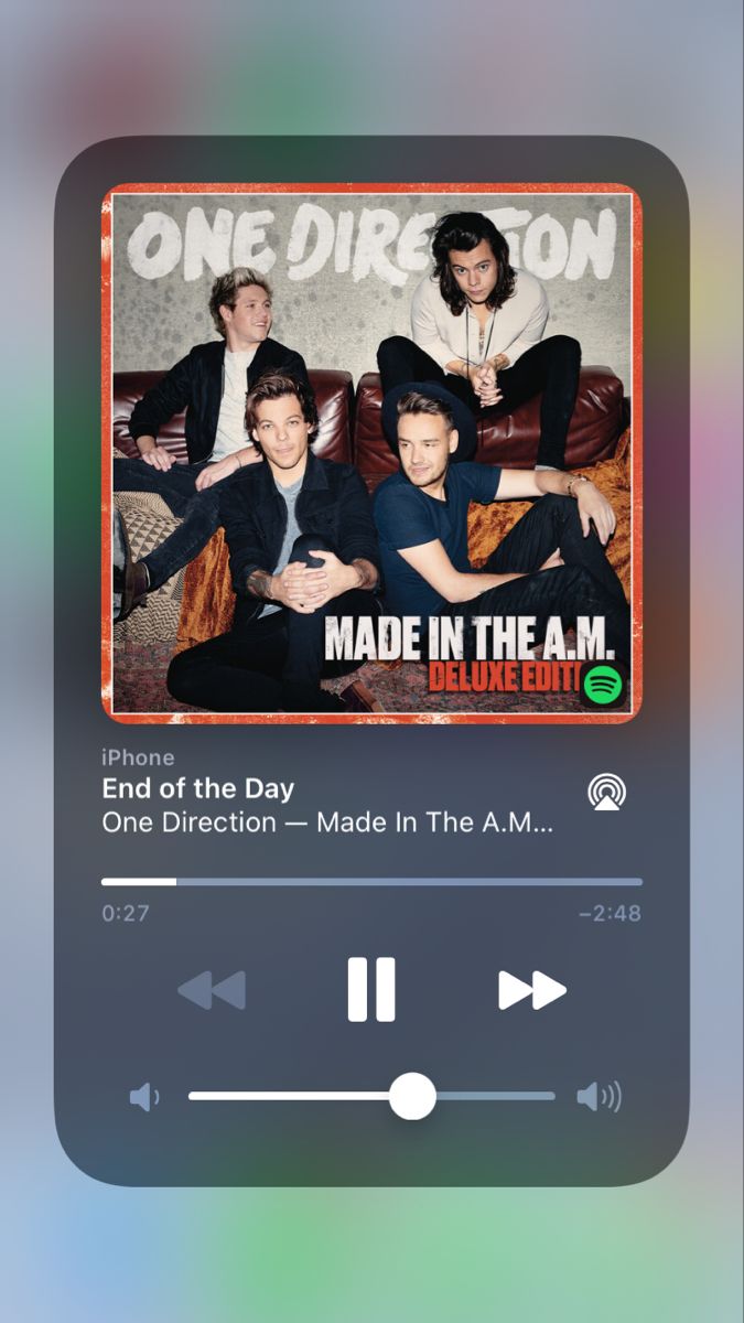 the one direction app on an iphone with music player and audio player in front of it