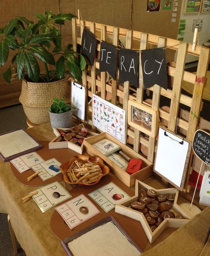 a wooden table topped with lots of cards and boxes filled with books on top of it