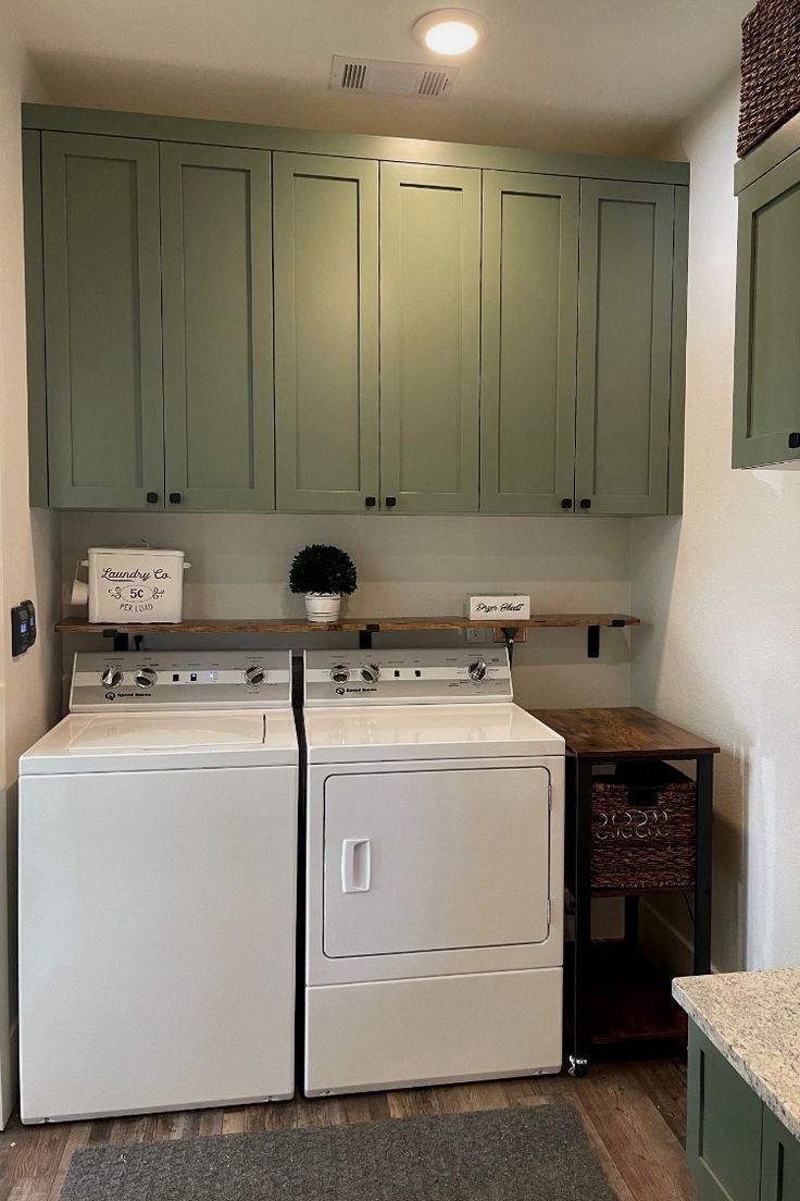 a white washer and dryer sitting next to each other in a laundry room