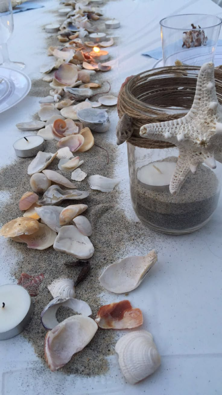 a table with shells and candles on it