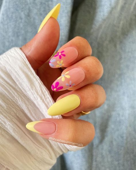 a woman's hand with yellow and pink nails