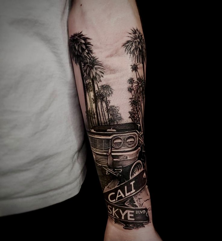 a man's arm with a car and palm trees on it