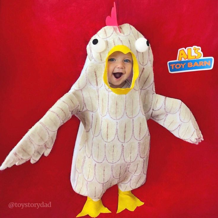 a little boy in a chicken costume on a red background with an ad for toys r us