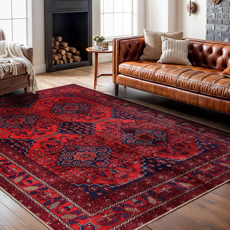 a living room with leather couches and a red rug on the floor in front of a fireplace