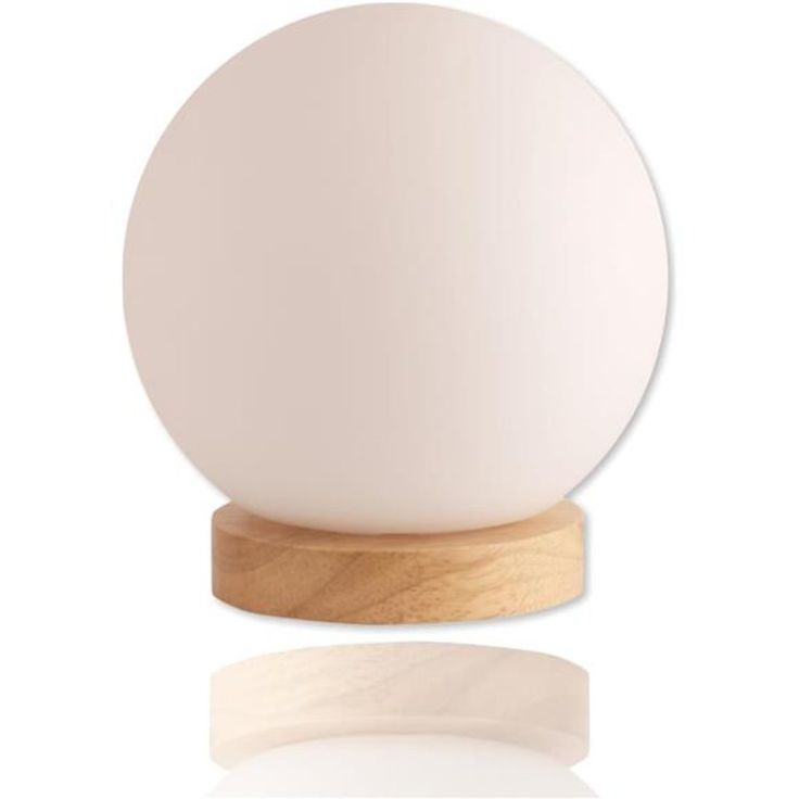 a white ball sitting on top of a wooden stand