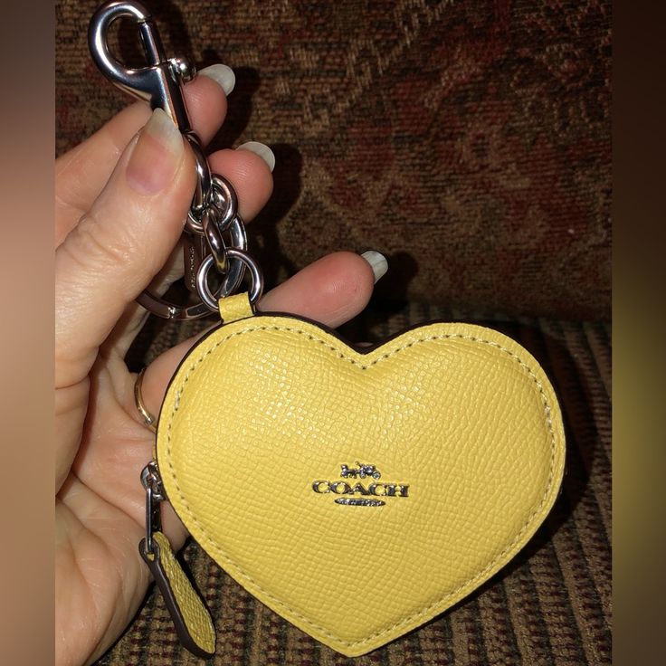 *Nwt-Coach-Heart Bag Charm/Coin Purse-Keychain-Light Yellow-$128: *Product Details: Crossgrain Leather Color: Light Yellow Zip Closure Silver-Tone Hardware Attached Split Key Ring & Dogleash Clip Fabric Interior Lining 3-1/2" L X 3" H X 0.5" W Style: Cp368 Msrp $128 + Tax *Smoke-Free Home. *Shipped Promptly-Usually The Same Day As Purchased. If Not Possible, Then Item Will Be Shipped Out The Next Available Business Day. Coin Purse Keychain, Purse Keychain, Coach Keychain, Heart Bag, Love Charms, Coach Accessories, Key Card Holder, Light Yellow, Key Ring