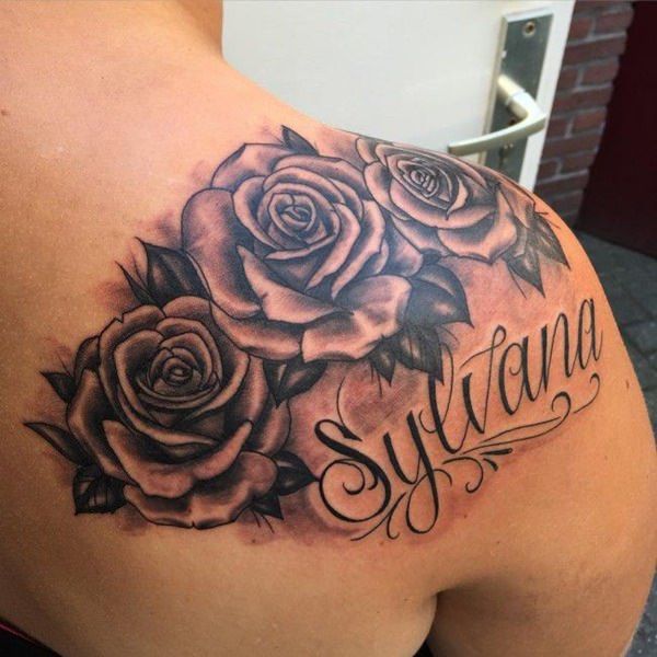 a woman's back with roses and the word sytiana on her shoulder