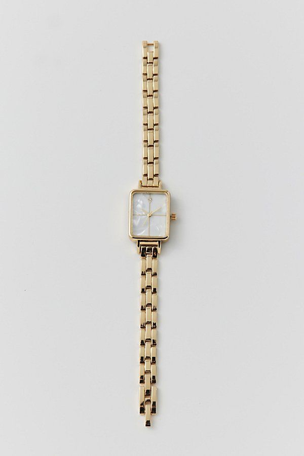 Classic metal rectangle watch. Essential watch style with a linked chain in polished metal complete with a rectangle style face. Features Classic metal rectangle watch Linked banded watch with rectangle face Content + Care Mixed metal, glass Avoid contact with water Imported Size Strap length: 7.24" l Case: .98" x .78" | Classic Metal Rectangle Watch in Gold, Women's at Urban Outfitters Rectangle Womens Watch, Womans Gold Watch, Womens Gold Watch Outfit, Cute Last Minute Birthday Gifts, Gold Square Watches Women, Vintage Looking Jewelry, Womens Christmas List 2024, Dainty Women’s Watch, Small Dainty Watch