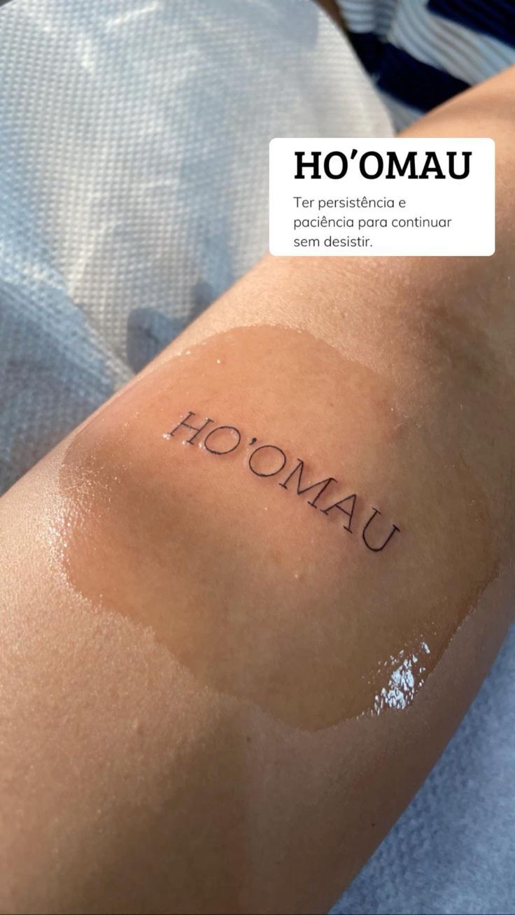 a person with a tattoo on their arm that says hoomau and the words hoomanu are written in cursive font