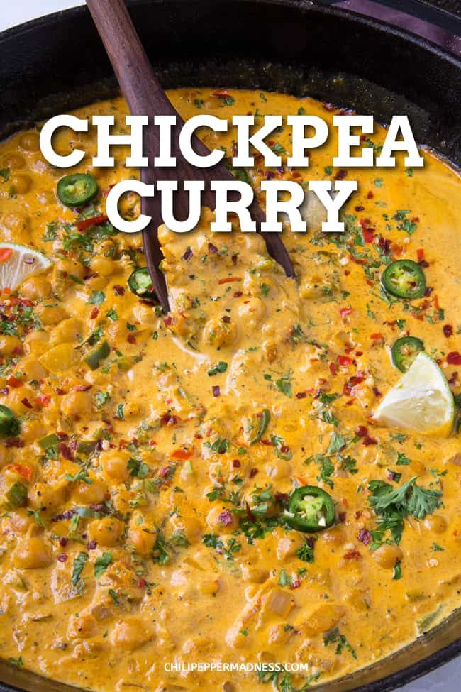 chicken curry in a black skillet with a wooden spoon and text overlay that reads, chickpea curry