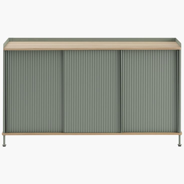 The Enfold Sideboard (2018) combines industrial materiality with residential references for a new perspective on modern storage. Made from lacquered steel that gently enfolds its solid wood top and bottom, it fuses cold and warm materials for a unique expression, paired with the vibrantly modern look of its ridged steel doors. Made in Sweden. | Enfold Sideboard, Tall Wide, Oak/Dusty Green at Design Within Reach Steel Front Door, Dusty Green, Steel Panels, Storage Credenza, Credenza Sideboard, Modern Storage, Grey Oak, Design Within Reach, Steel Doors