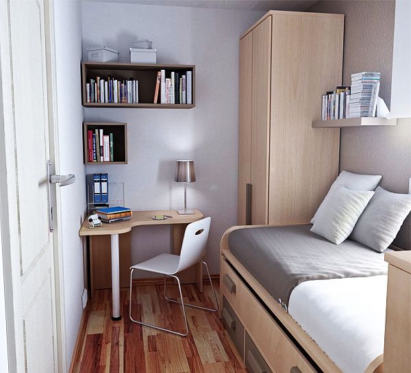 a small bedroom with a bed, desk and bookshelf