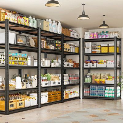 a large metal shelving unit with lots of items on it and hanging lights above the shelves