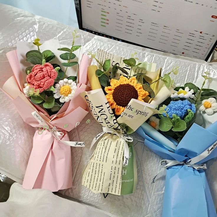 three bouquets of flowers sitting on top of a table