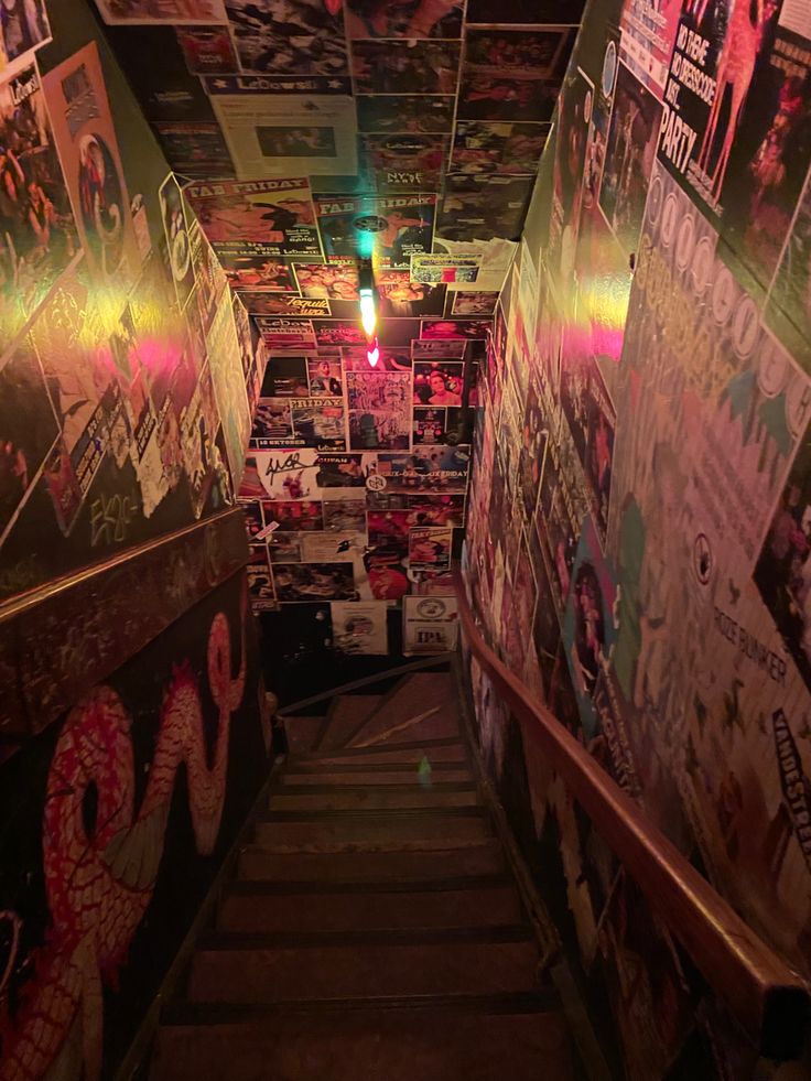 the stairs are covered with posters and lights