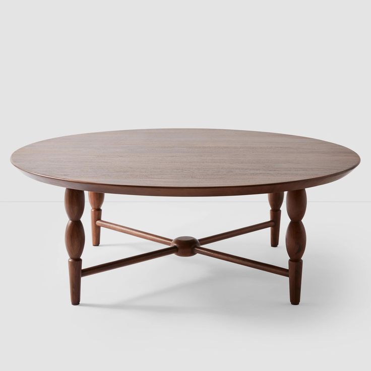 an oval wooden table with two legs and a circular top, on a white background