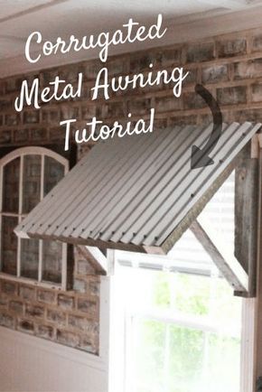 a metal awning hanging from the side of a brick wall