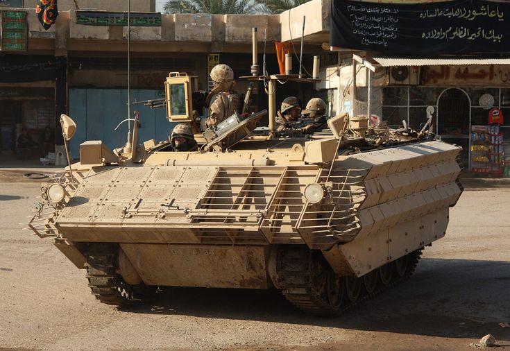 an army tank is parked on the street