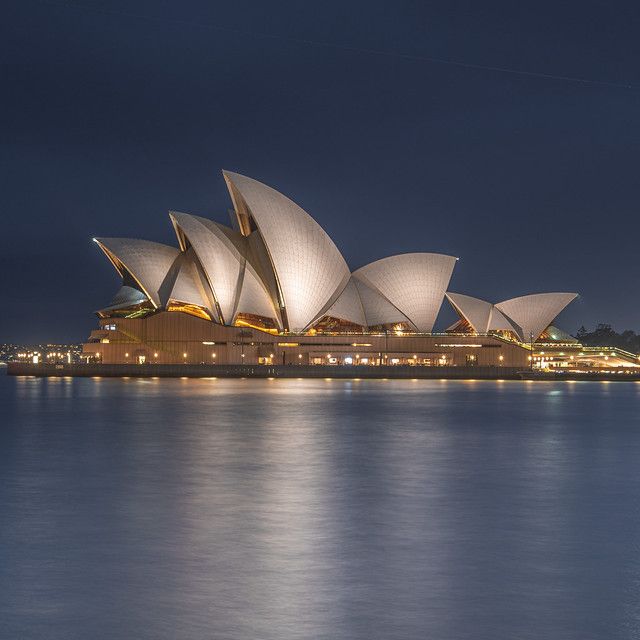 the sydney opera house lit up at night