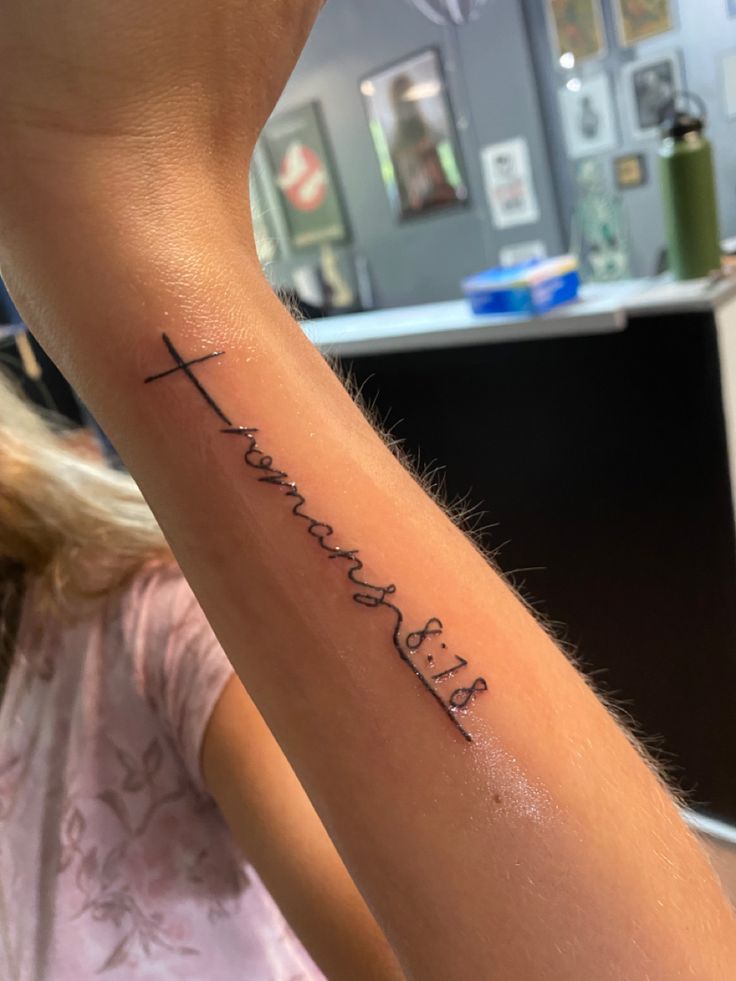 a woman with a tattoo on her arm that says, faith