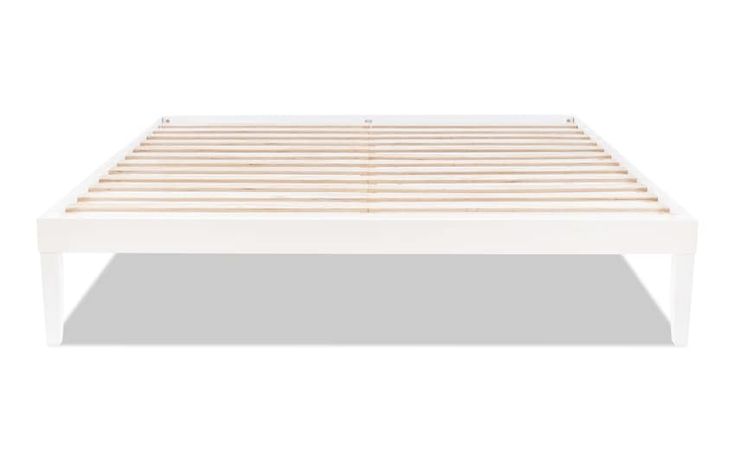 a white bed frame with wooden slats on the top and bottom, against a white background