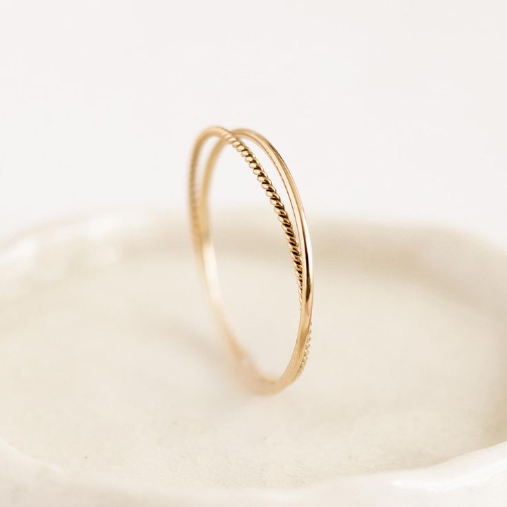 a close up of a ring on a white plate with a small object in the background