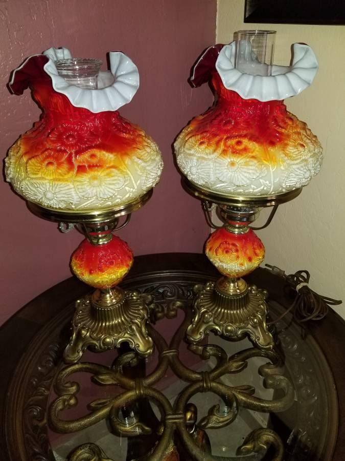 two red and yellow lamps sitting on top of a table