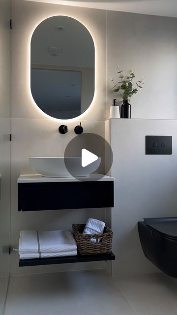 a bathroom with a sink, mirror and towel rack