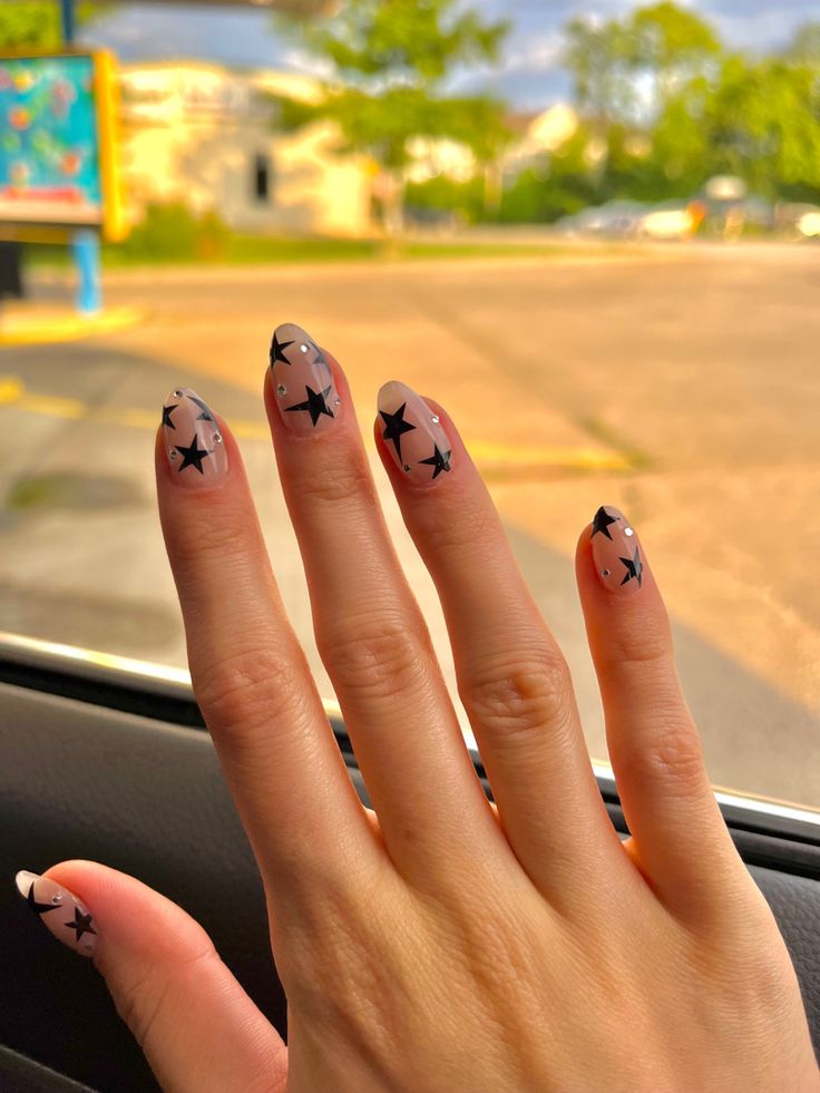 Oval Nails Star Design, Nails Acrylic Almond Stars, Medium Length Star Nails, White Star Almond Nails, Short Aesthetic Almond Nails, Clear Nails With Black Stars, Minimal Star Nails, Stars Nails Short, Sparkly Nails With Stars