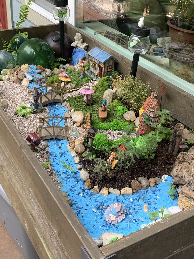 a small garden is displayed in a window