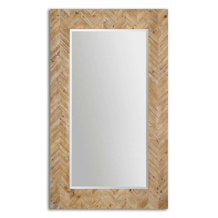 a mirror that is sitting on top of a wooden frame with a white wall in the background