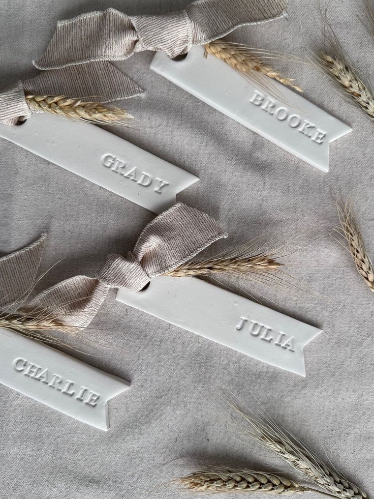 three tags with the names of different types of wheat on them, tied together and placed next to each other