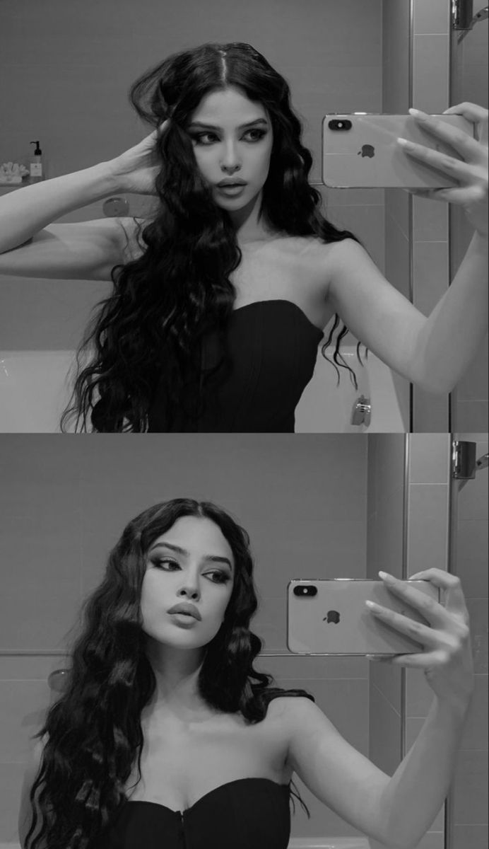 a woman taking a selfie in front of a mirror