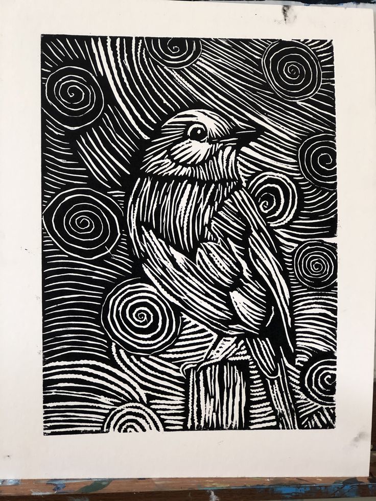 a black and white drawing of a bird sitting on top of a piece of paper