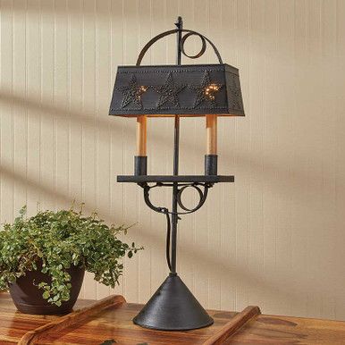 a table with a lamp and potted plant on it next to a cutting board