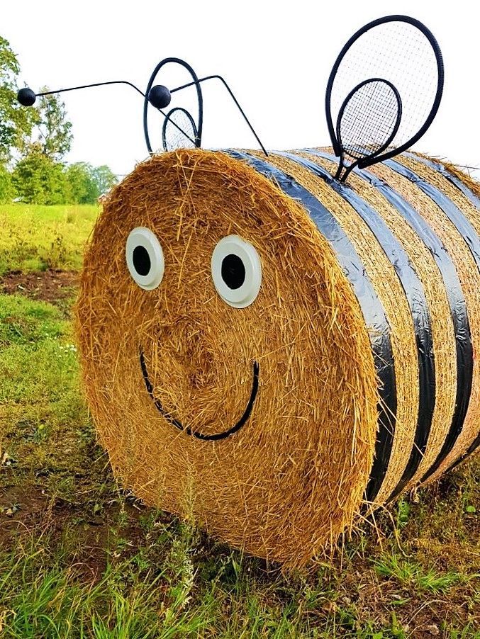 a hay bale with a face drawn on it