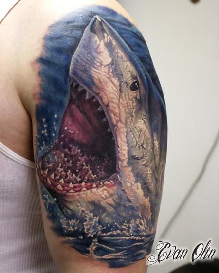 a man with a shark tattoo on his arm and shoulder, showing it's teeth